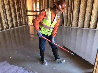 Gypsum flooring being installed in new construction
