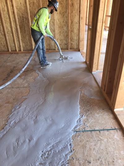 Insul-Flow employee installing gypcrete flooring in new construction